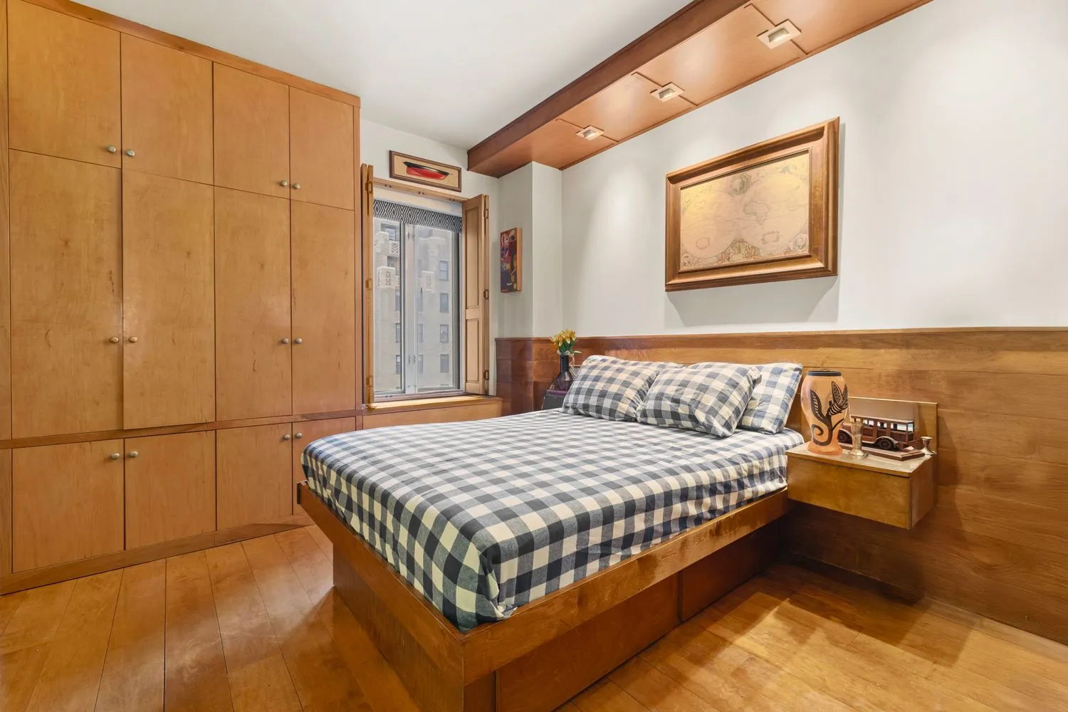 a bedroom with a bed and cabinets