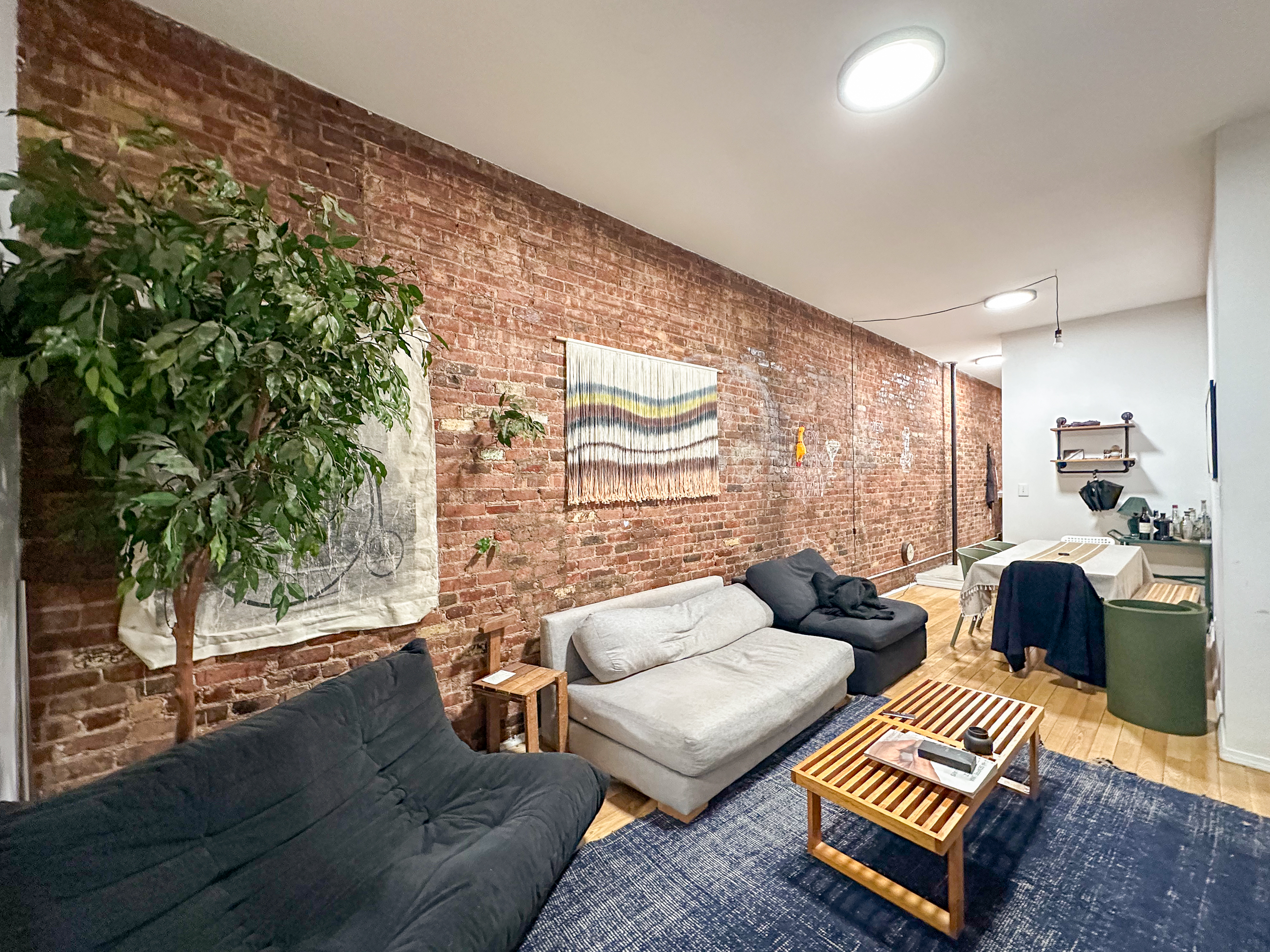 213 East 5th Street, Unit 5 Manhattan, NY 10003 - Photo 5 of 17 a living room with furniture and a floor to ceiling window