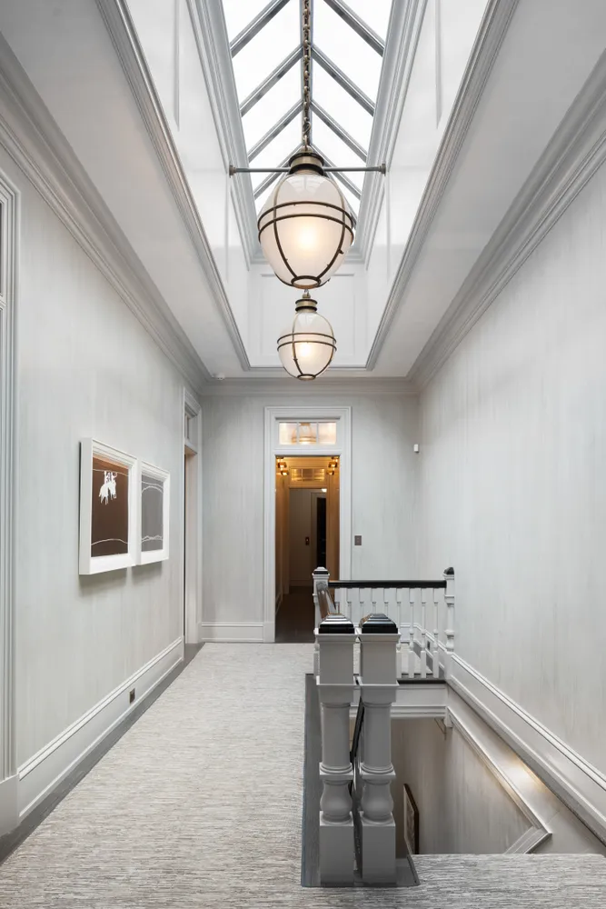 a view of a hallway with a chandelier and livingroom view