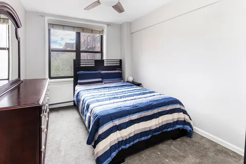 a bedroom with a bed and window