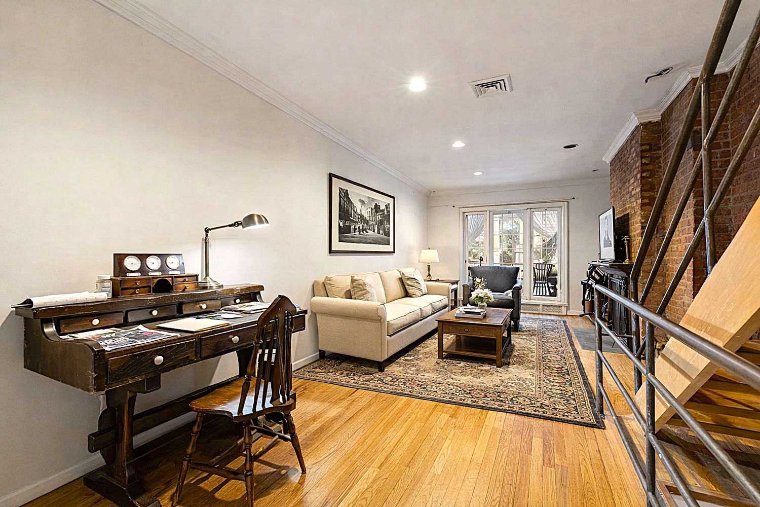 449 1/2 Hudson Street Manhattan, NY 10014 - Photo 2 of 19 a living room with furniture and a wooden floor