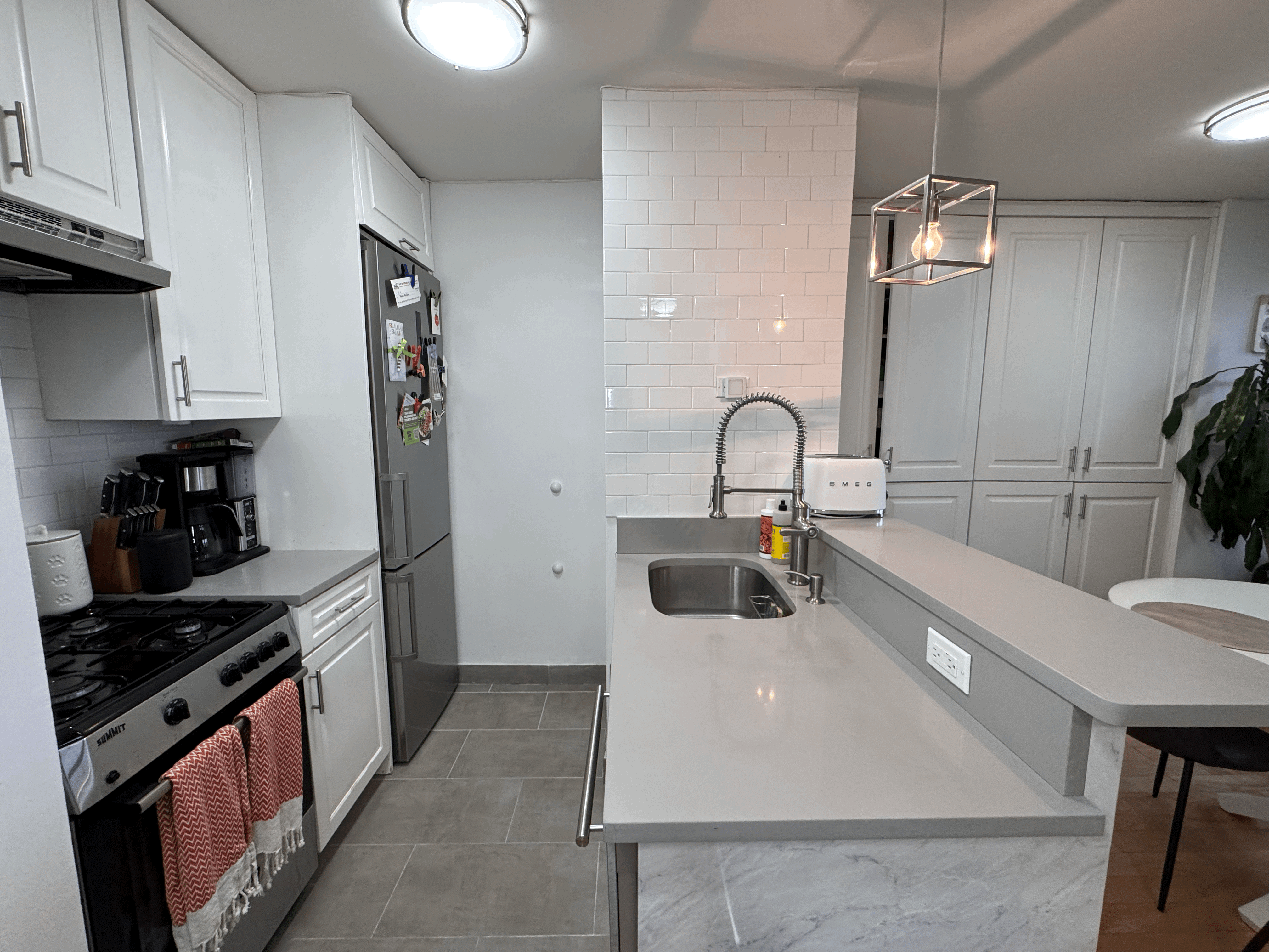 330 East 38th Street, Unit 38I Manhattan, NY 10016 - Photo 3 of 17 a kitchen with a refrigerator and a stove top oven