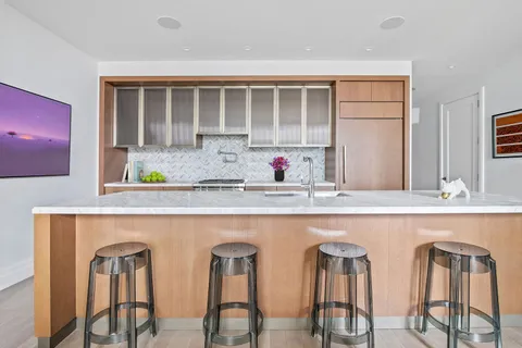 a kitchen with chairs and window