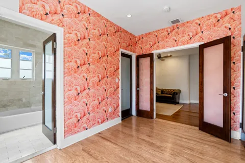 a view of a hallway with wooden floor and furniture