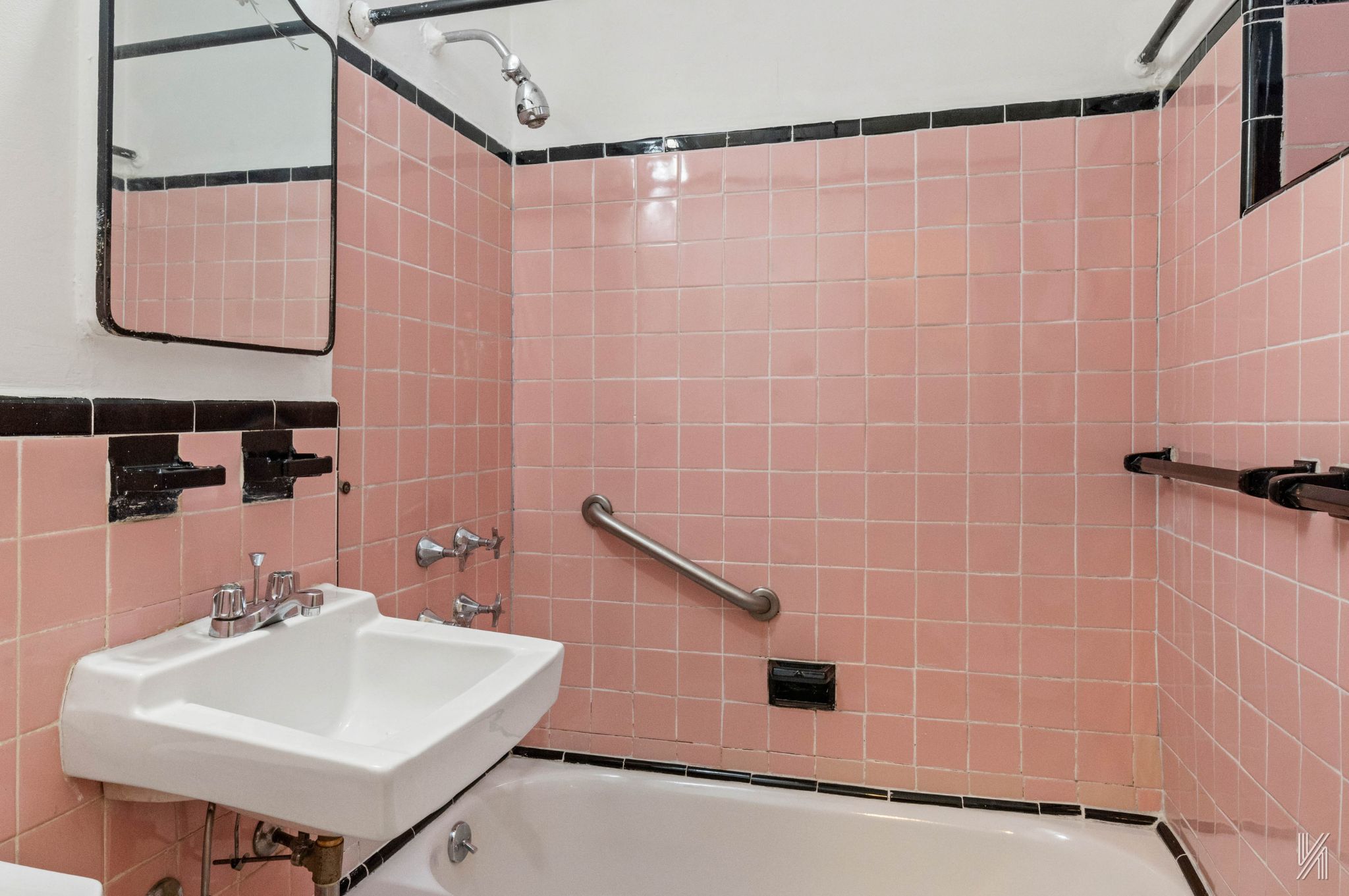 22-60 79th Street, Unit 1A Queens, NY 11370 - Photo 15 of 17 a bathroom with a sink a mirror and shower curtain