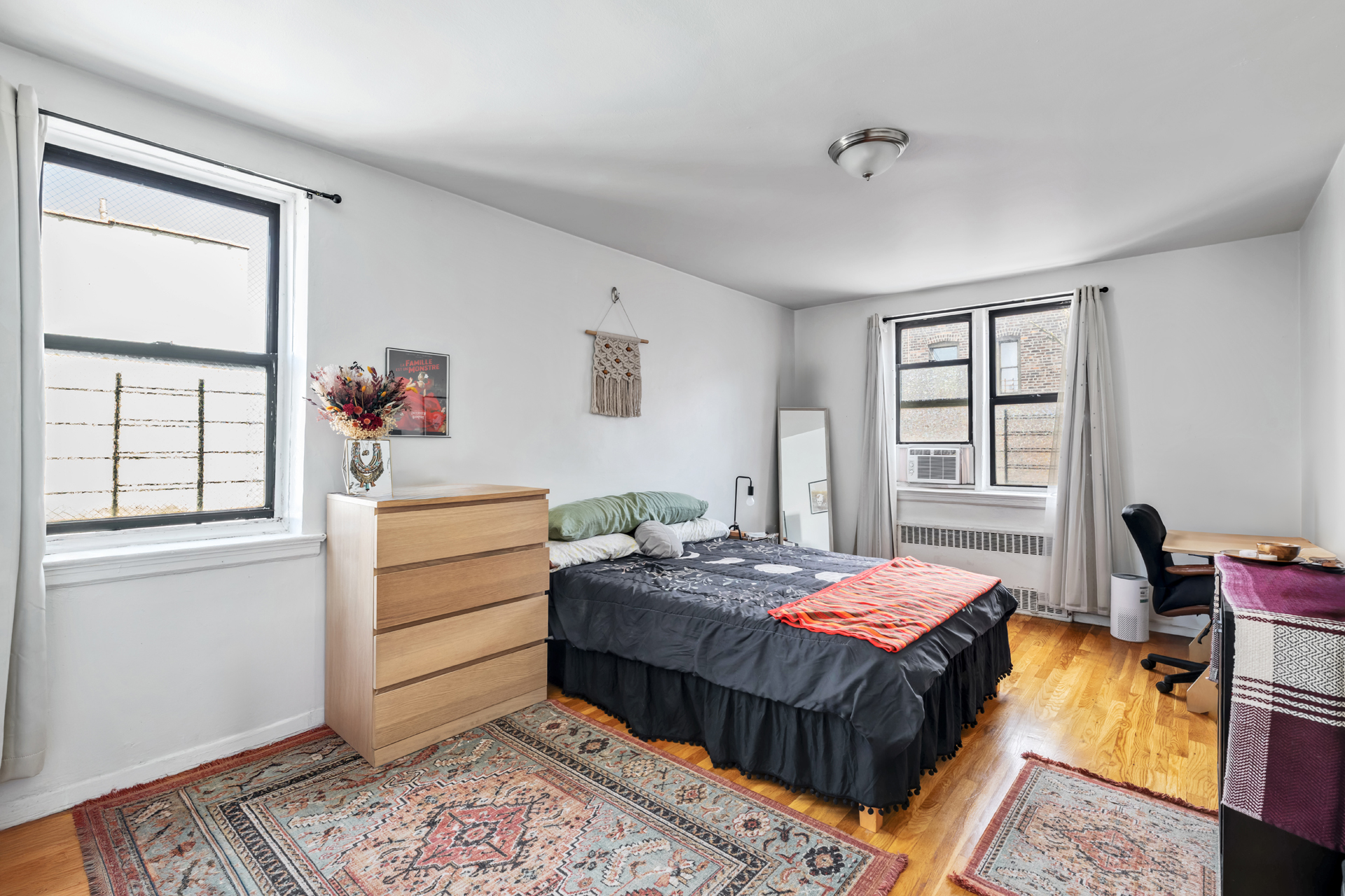 2420 Morris Avenue, Unit 5J Bronx, NY 10468 - Photo 4 of 6 a bedroom with a bed and wooden floor