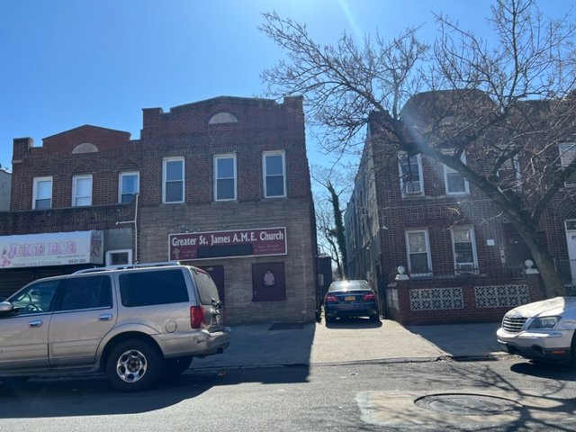 a car parked in front of a brick house