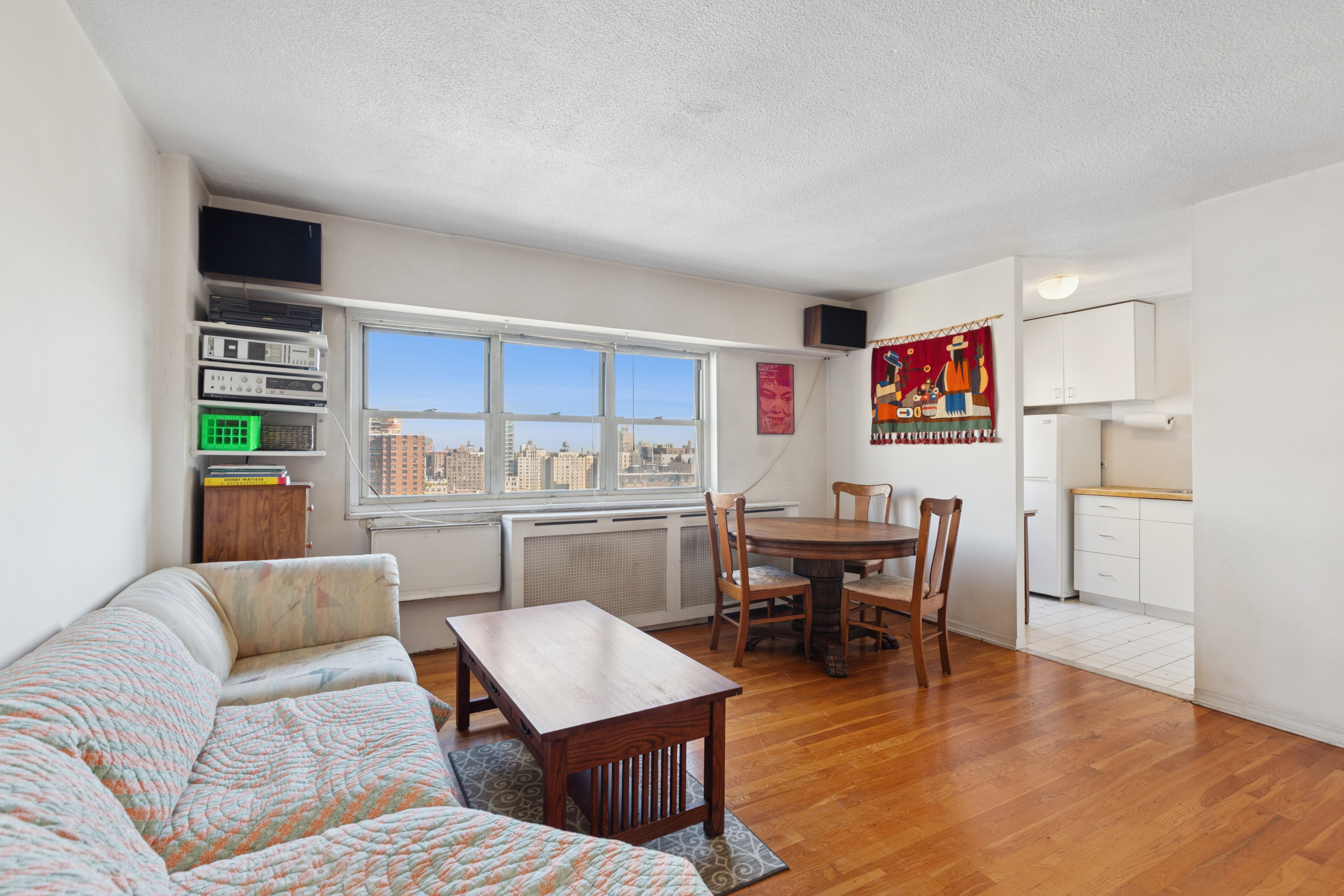 609 Columbus Avenue, Unit 18E Manhattan, NY 10024 - Photo 4 of 10 a living room with furniture and a kitchen view