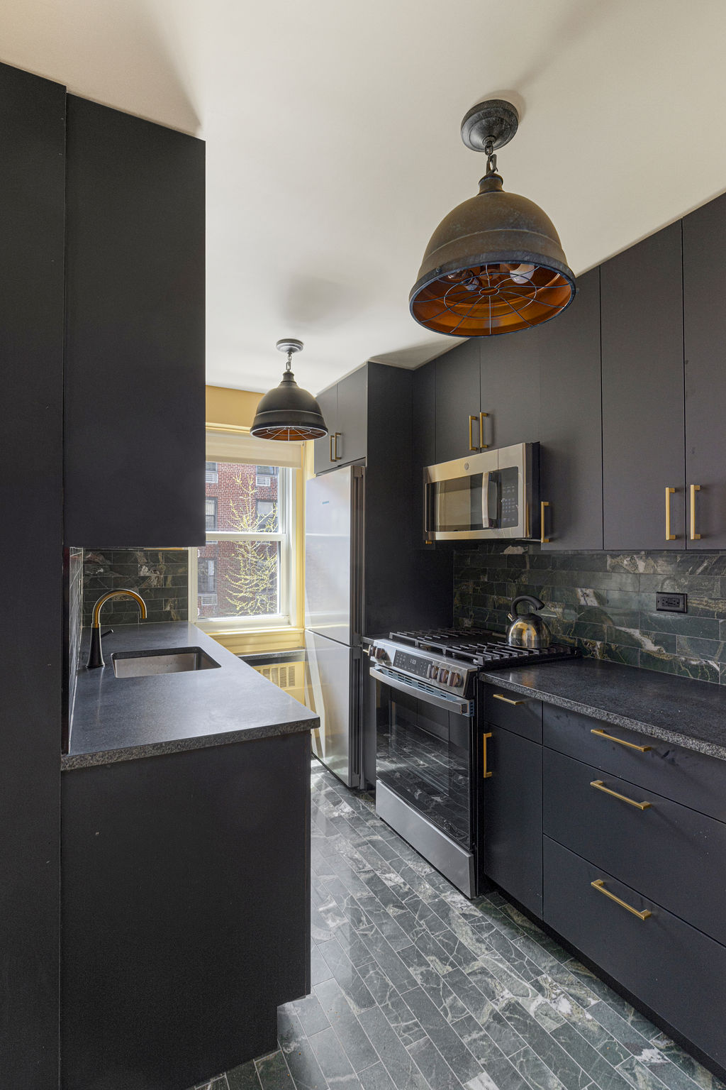 101 West 12th Street, Unit 5V Manhattan, NY 10011 - Photo 8 of 26 a kitchen with a stove and a sink