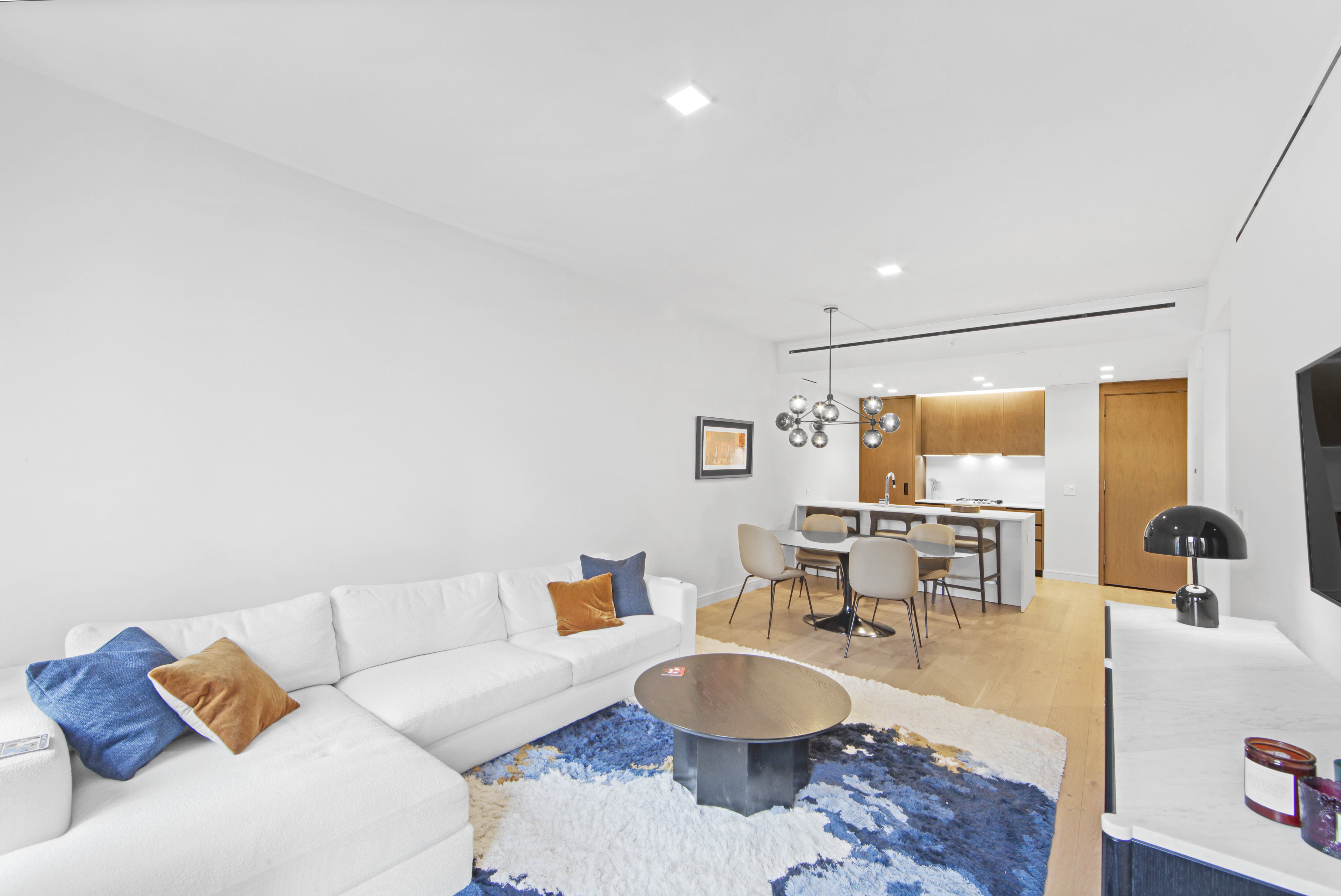 200 East 21st Street, Unit 4B Manhattan, NY 10010 - Photo 5 of 15 a living room with furniture and a table