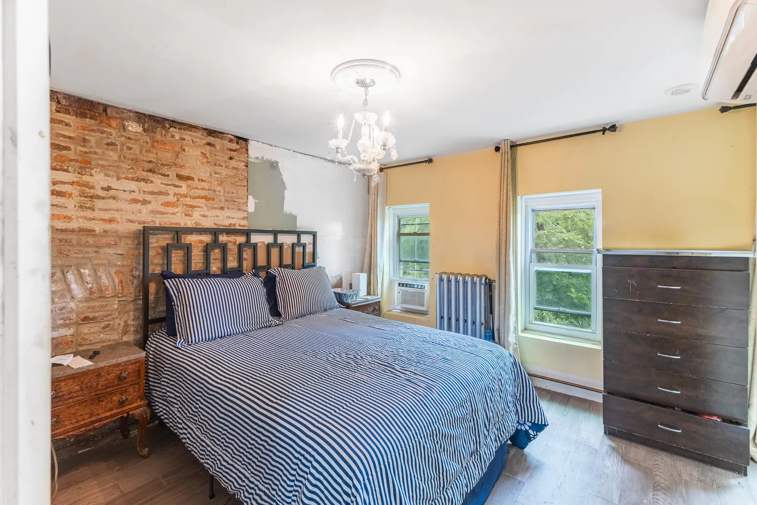 a bedroom with a large bed and a dresser