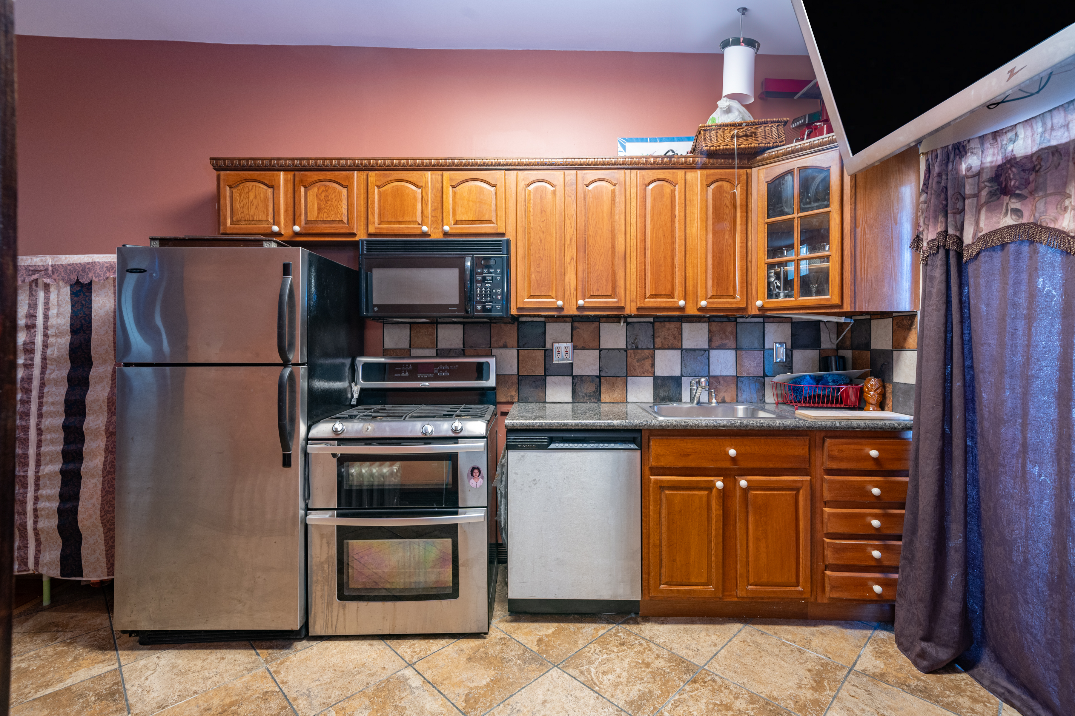 415 84th Street Brooklyn, NY 11209 - Photo 15 of 17 a kitchen with stainless steel appliances granite countertop a refrigerator and a stove