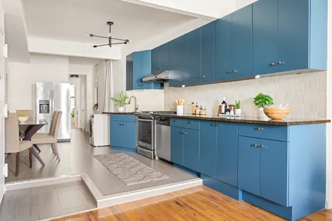 a kitchen with stainless steel appliances wooden cabinets a stove and a sink