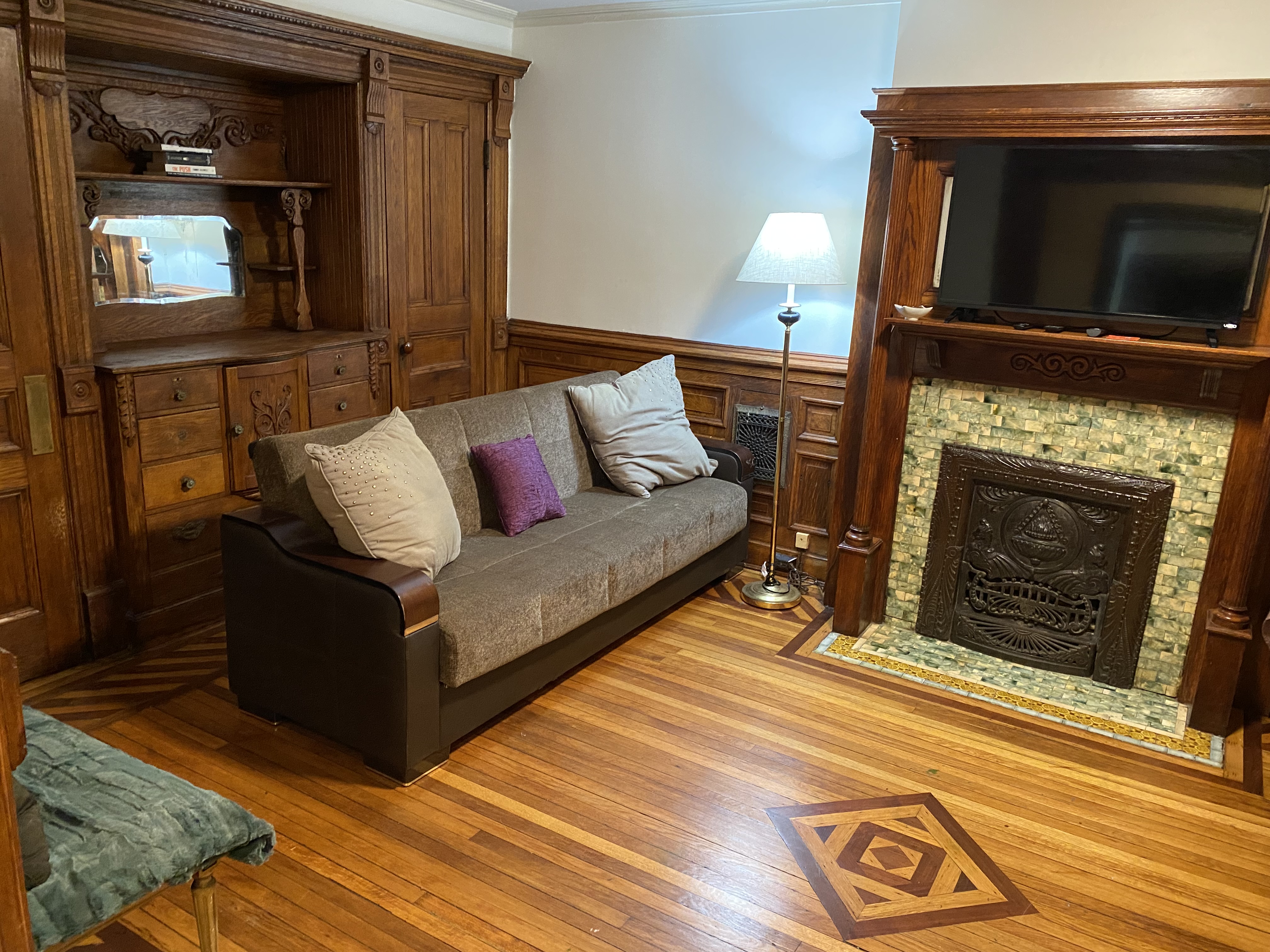 493 Decatur Street, Unit 1 Brooklyn, NY 11233 - Photo 10 of 26 a living room with furniture and a fireplace