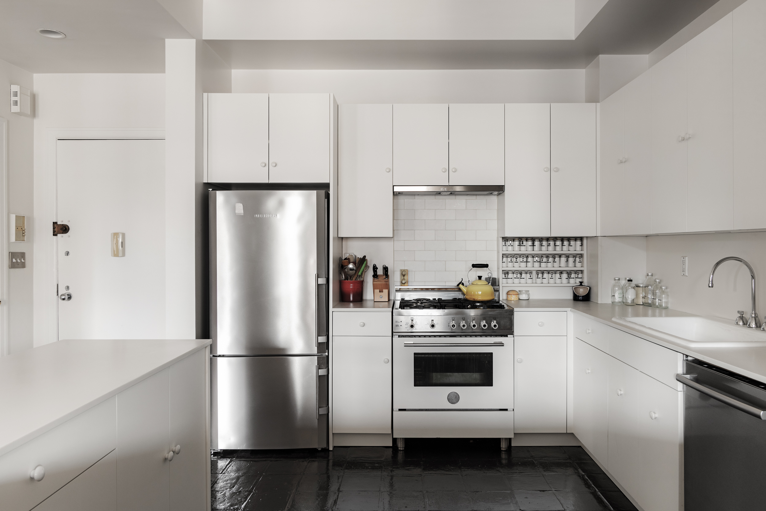 260 West Broadway, Unit 10D Manhattan, NY 10013 - Photo 7 of 20 a kitchen with stainless steel appliances a refrigerator a sink and white cabinets