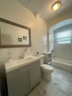 a bathroom with a toilet sink and mirror