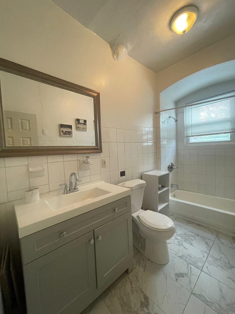 88-13 Corona Avenue, Unit 2 Queens, NY 11373 - Photo 7 of 7 a bathroom with a toilet sink and mirror