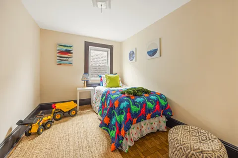 a bedroom with a bed and a lamp on table