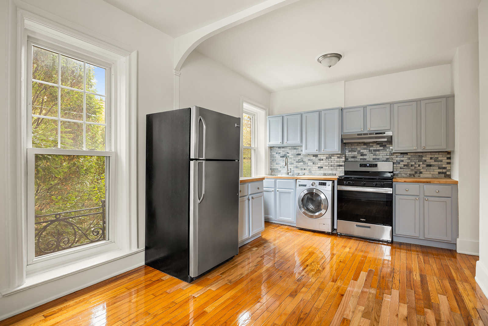 1523 11th Avenue, Unit 2 Brooklyn, NY 11215 - Photo 3 of 11 a kitchen with granite countertop a refrigerator and a stove top oven