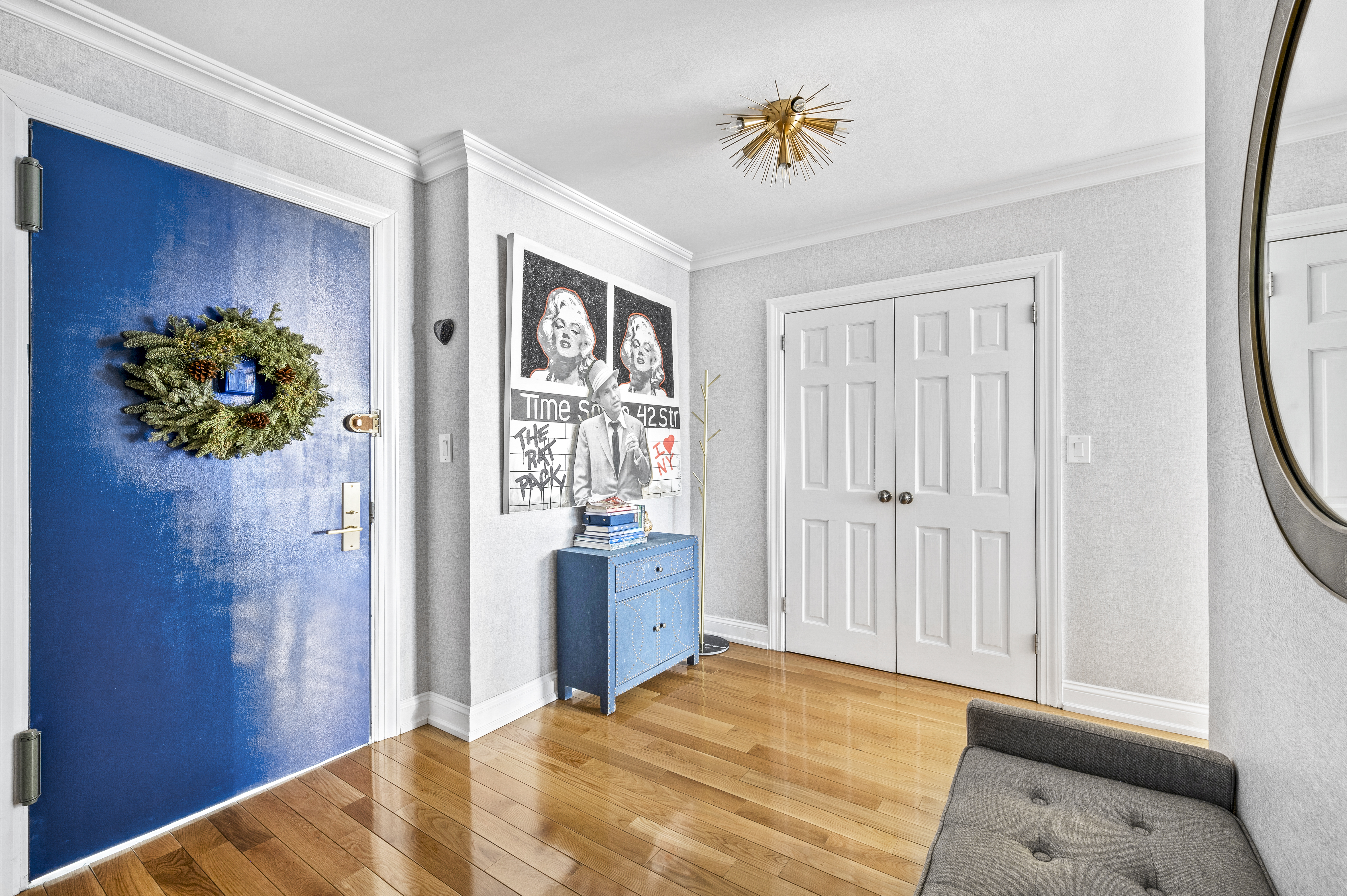 201 East 79th Street, Unit 6A Manhattan, NY 10075 - Photo 5 of 11 a bedroom with a bed and a chandelier