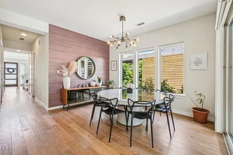a view of a dining room with furniture window and wooden floor