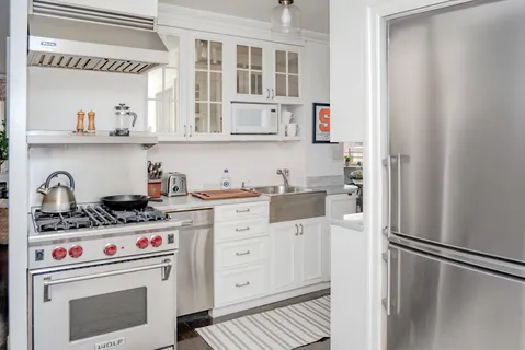 a kitchen with stainless steel appliances a refrigerator and a stove top oven