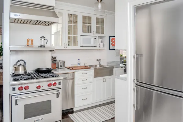 a kitchen with stainless steel appliances a refrigerator and a stove top oven