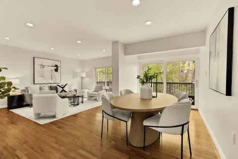 a dining room with furniture and wooden floor