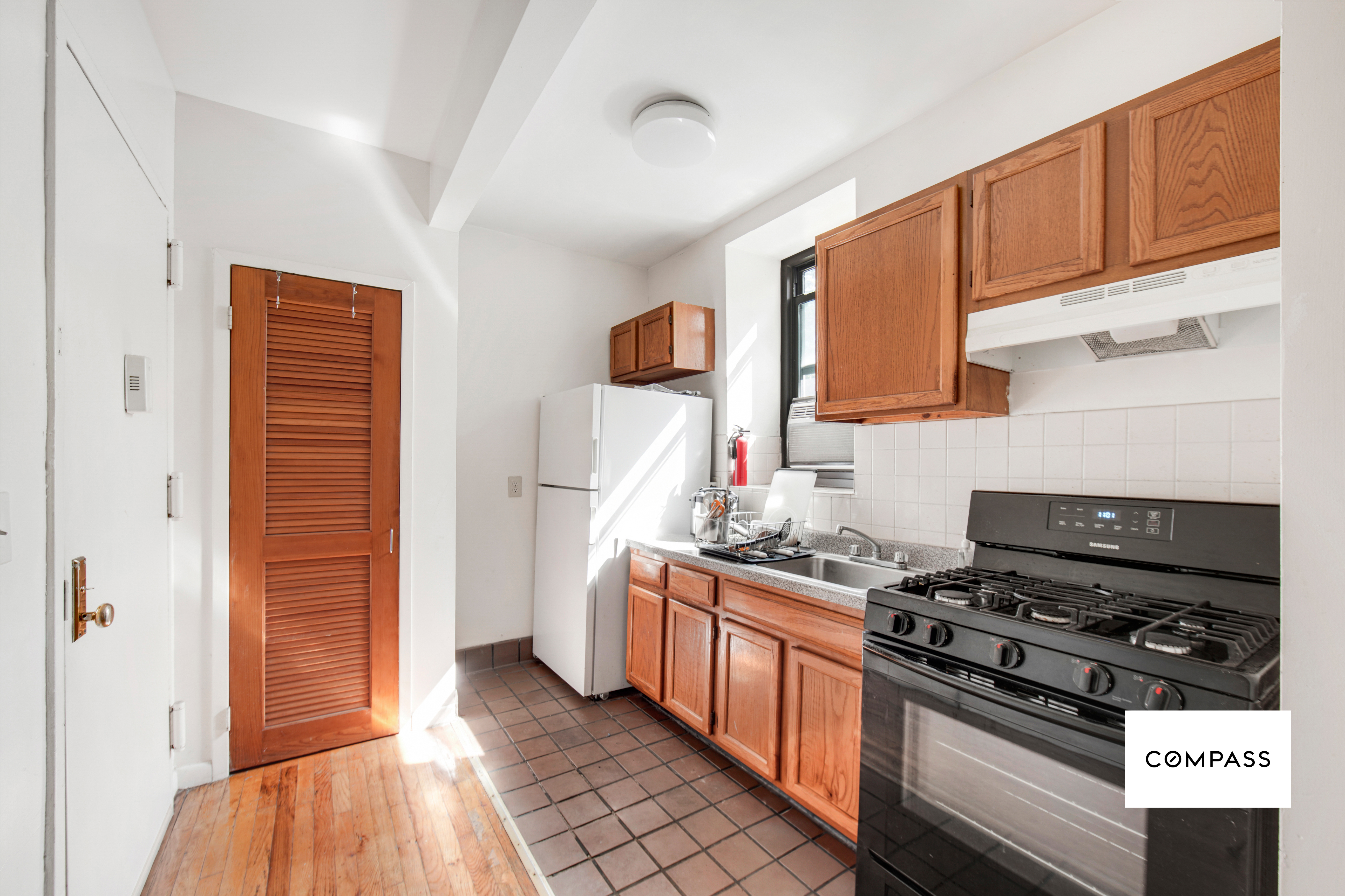 80 St Nicholas Avenue, Unit 1E Manhattan, NY 10026 - Photo 5 of 6 a kitchen with stainless steel appliances a stove and a refrigerator