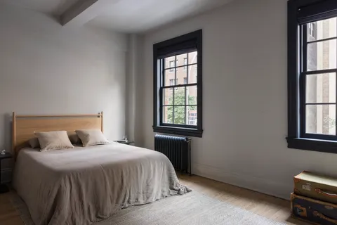 a bedroom with a bed and window