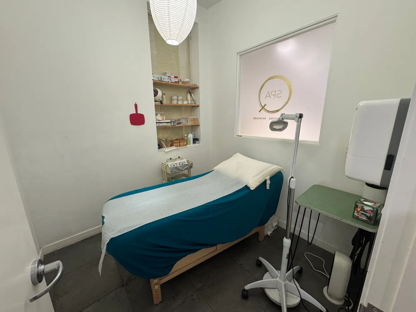 a bedroom with a bed a lamp and a window