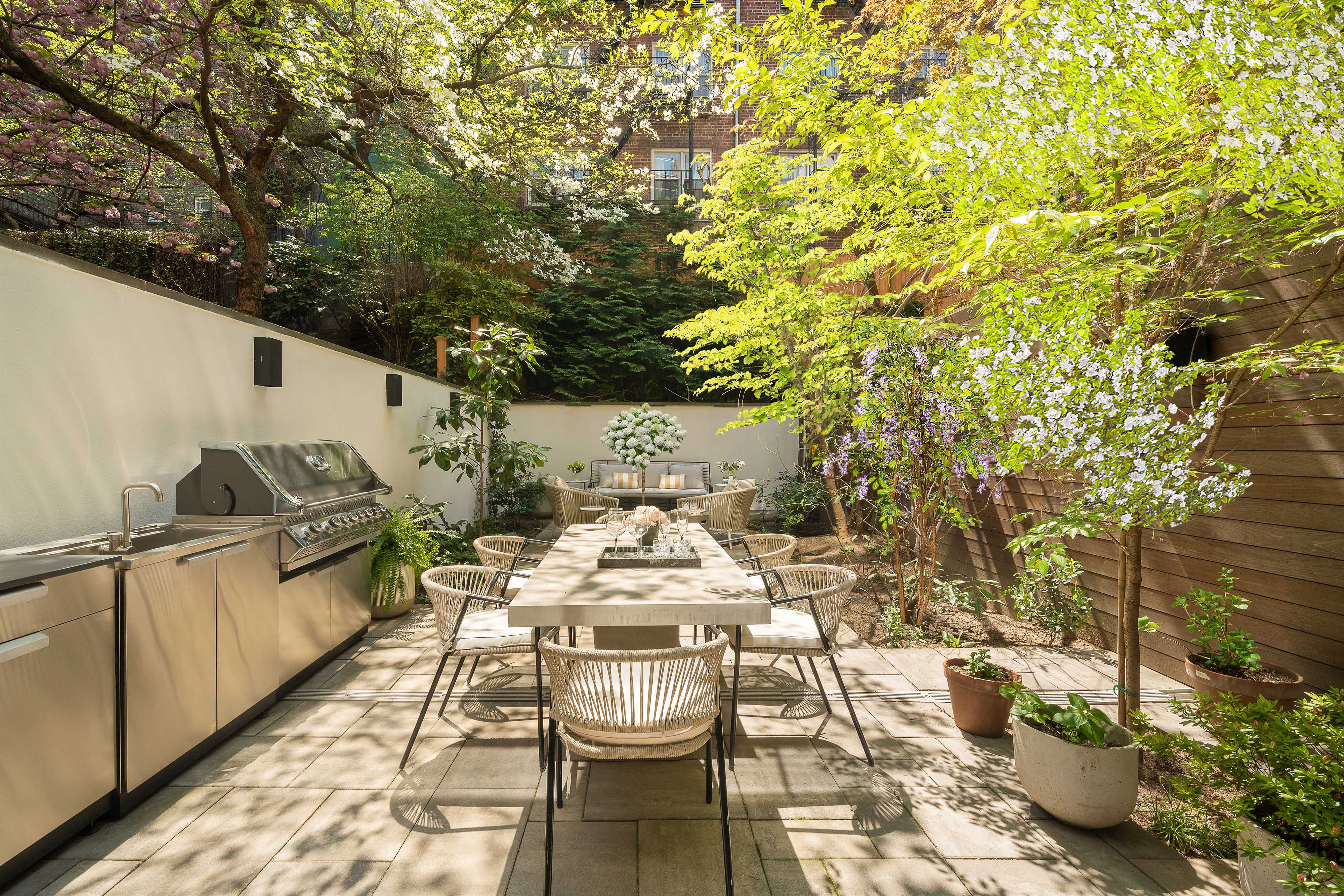 520 East 89th Street Manhattan, NY 10128 - Photo 19 of 40 a view of a patio with table and chairs and potted plants