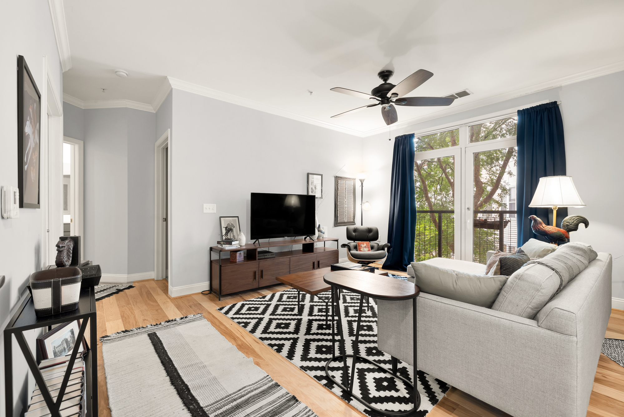 1391 Pennsylvania Ave. Southeast, Unit 324 Washington, DC 20003 - Photo 8 of 33 a living room with furniture a flat screen tv and a large window