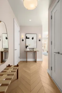a large white kitchen with a sink a counter space and stainless steel appliances