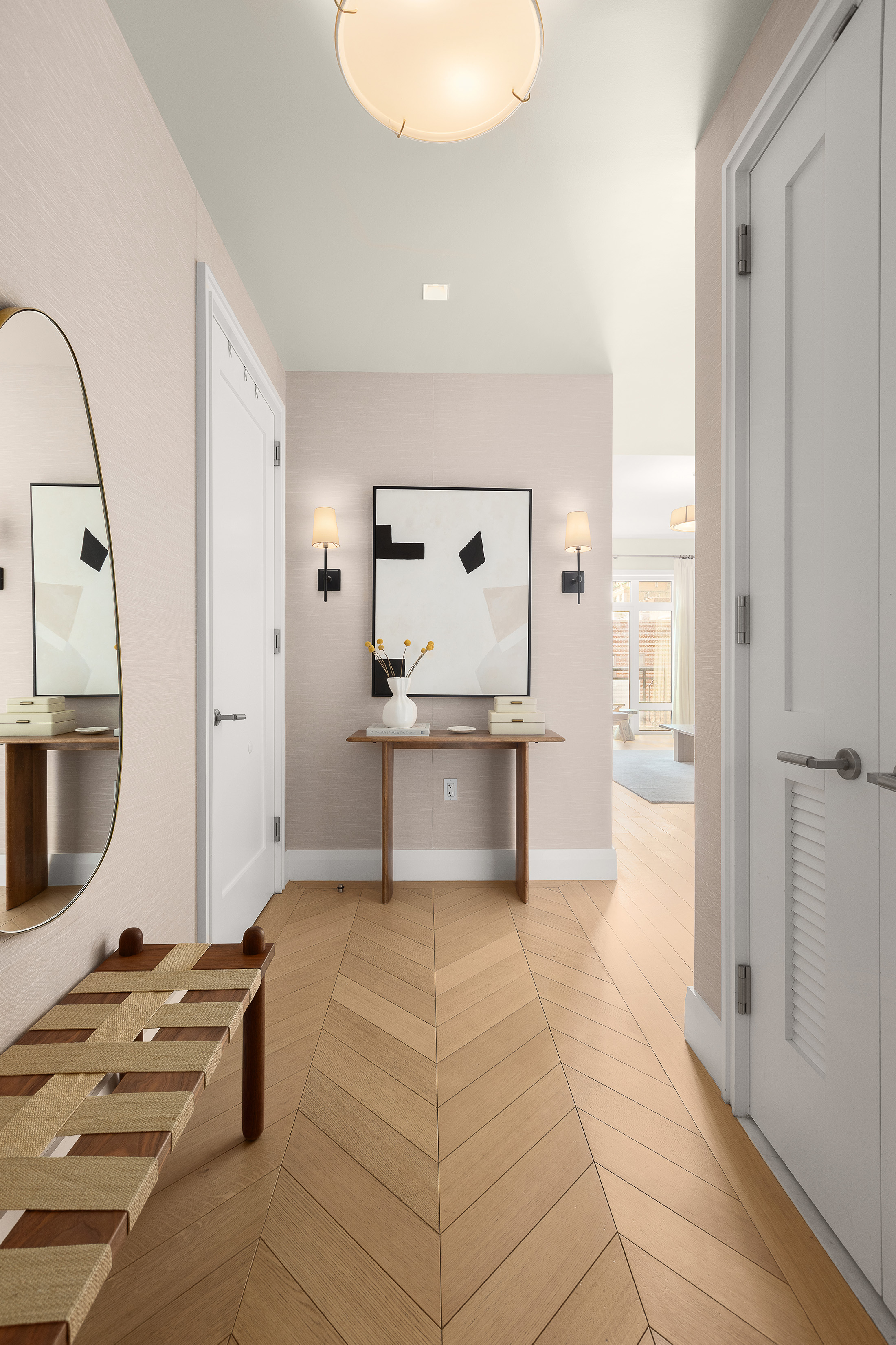 200 East 83rd Street, Unit 8C Manhattan, NY 10028 - Photo 5 of 26 a large white kitchen with a sink a counter space and stainless steel appliances