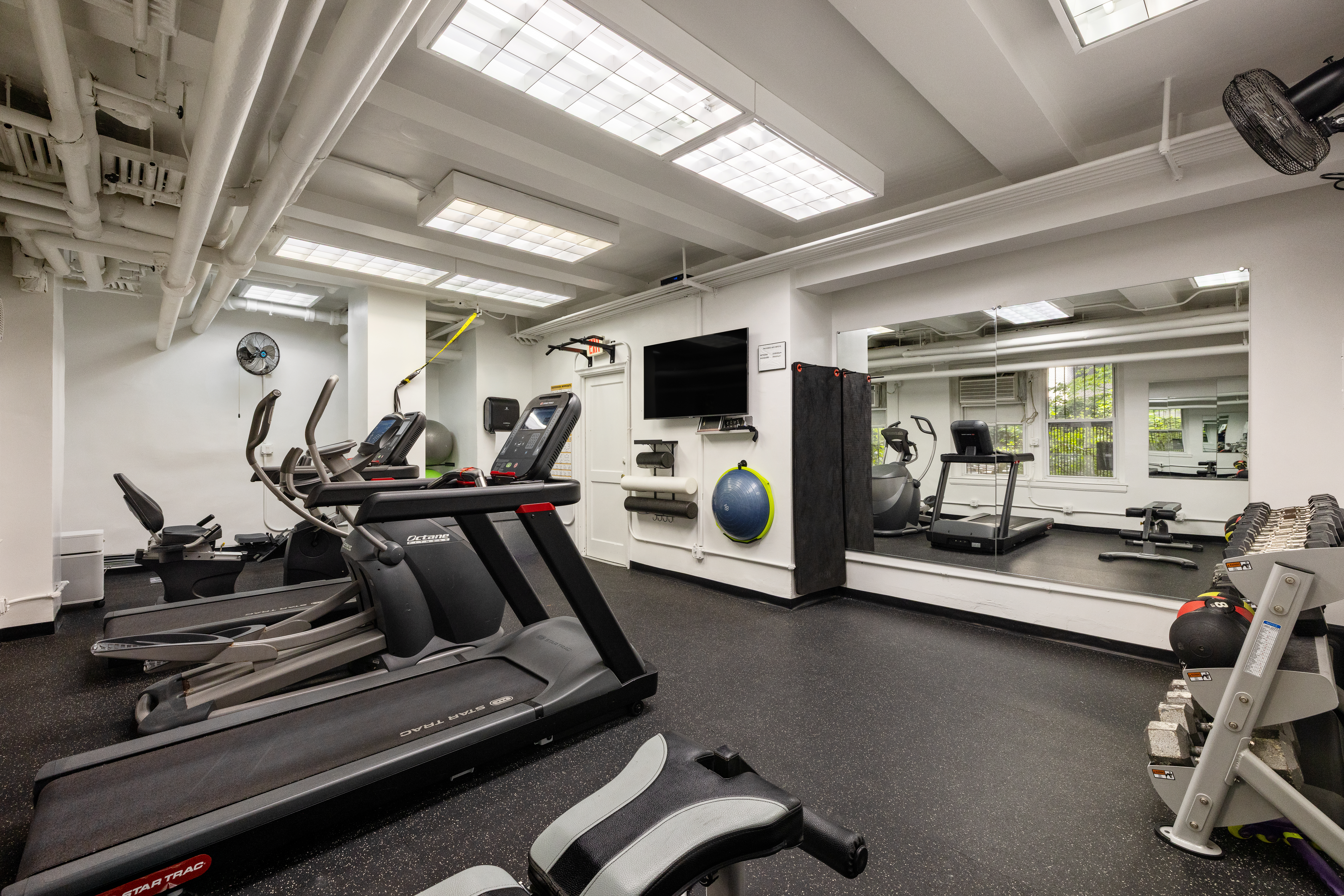 333 East 68th Street, Unit 8A Manhattan, NY 10065 - Photo 15 of 16 a view of a room with gym equipment
