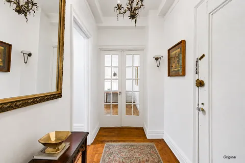 a view of a bedroom with furniture window and wooden floor