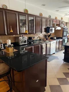 a kitchen with stainless steel appliances granite countertop a sink a stove and cabinets