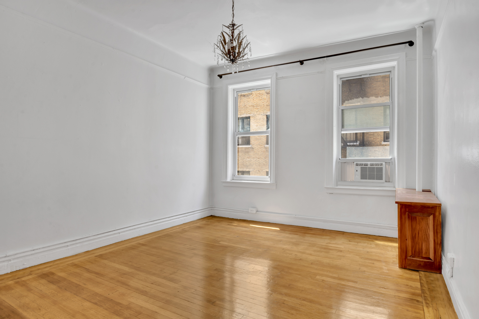 720 West 173rd Street, Unit 23 Manhattan, NY 10032 - Photo 8 of 10 a view of empty room with wooden floor and fan