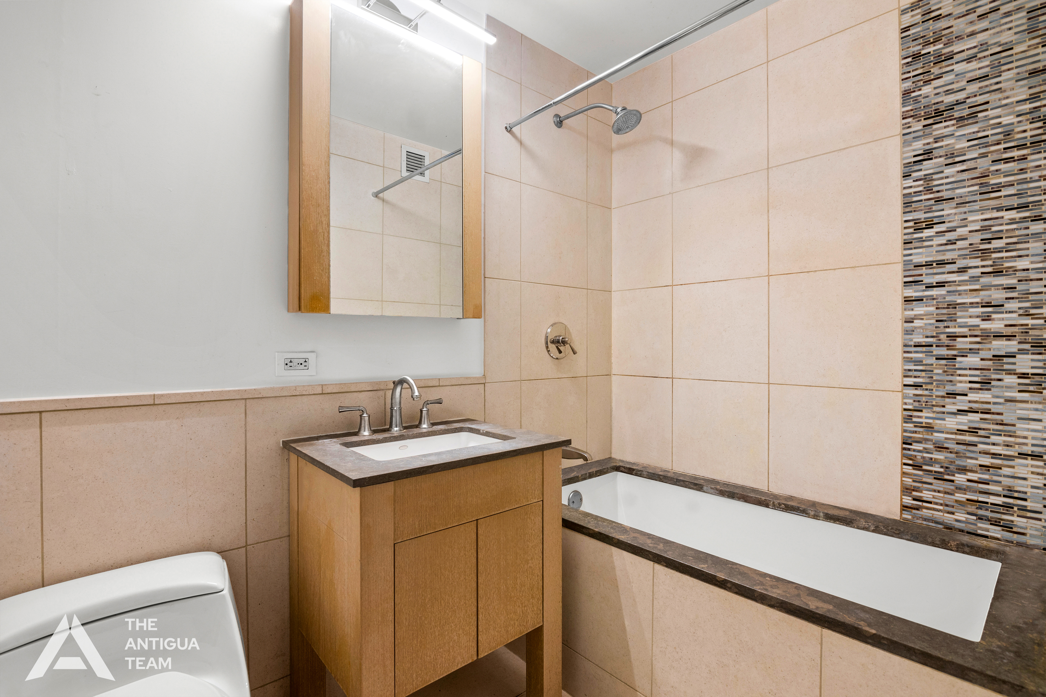 350 West 42nd Street, Unit 12C Manhattan, NY 10036 - Photo 7 of 21 a bathroom with a sink and a mirror