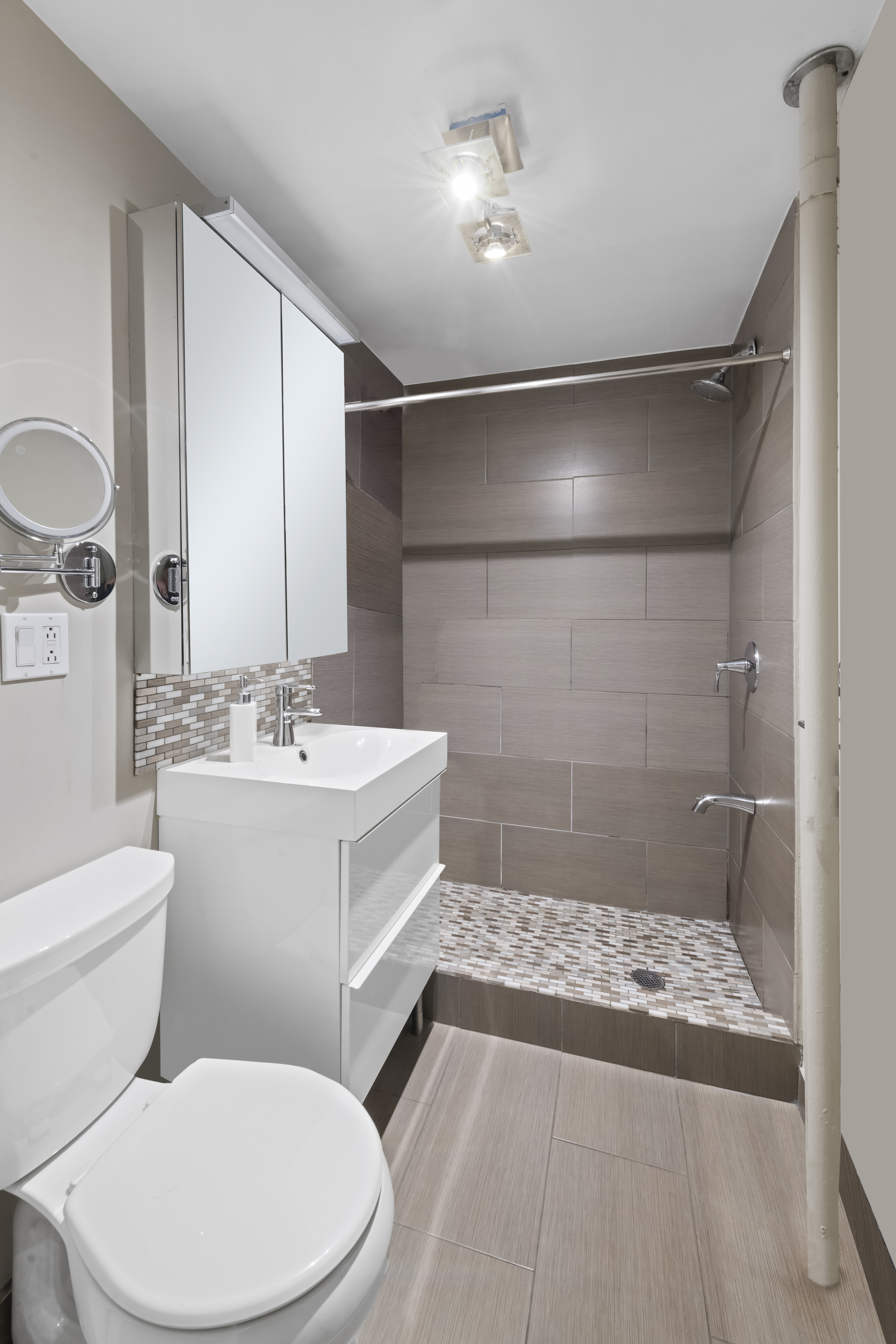 61 West 88th Street, Unit 1B/F Manhattan, NY 10024 - Photo 10 of 12 a bathroom with a sink a toilet and shower