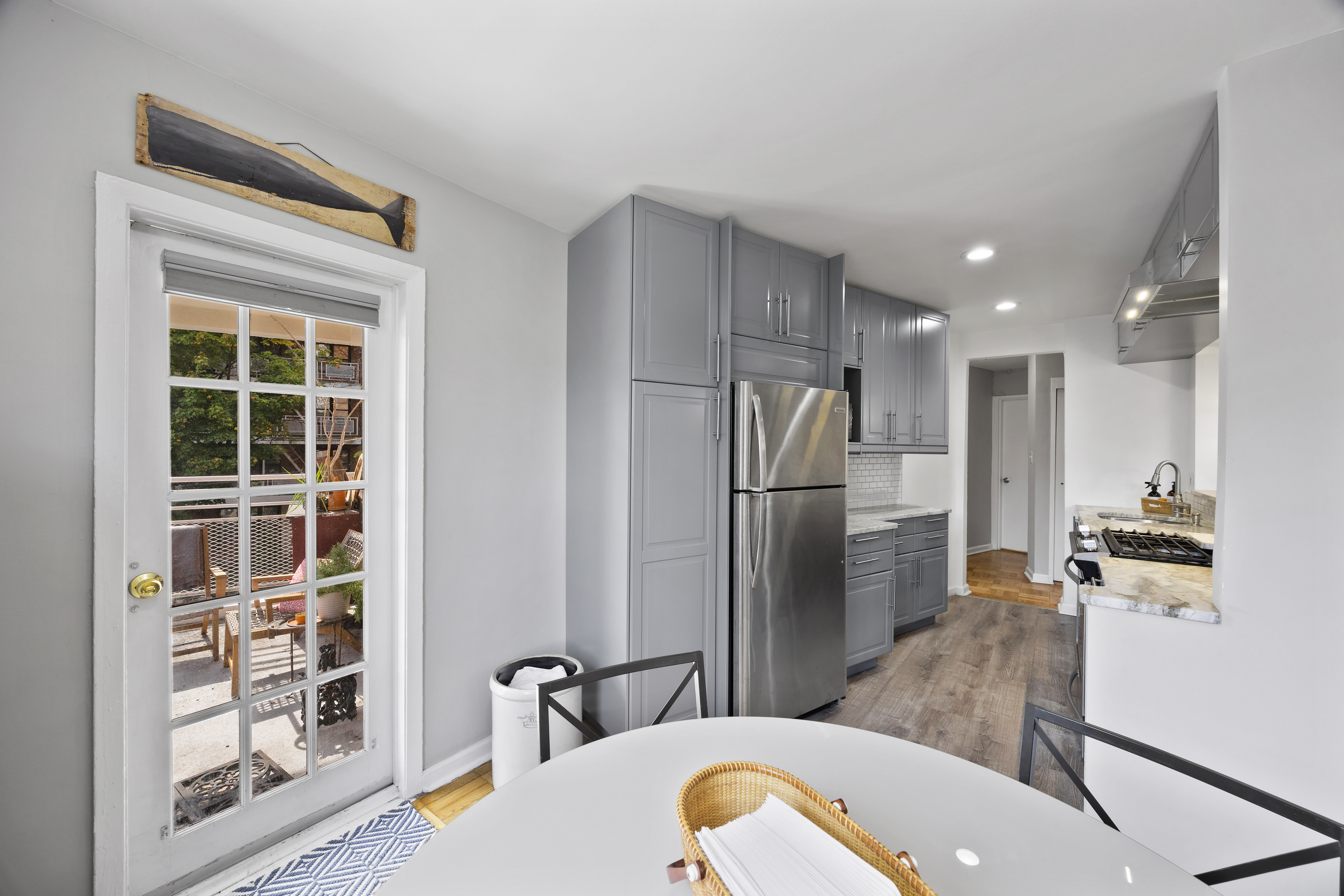 255 Fieldston Terrace, Unit 2L Bronx, NY 10471 - Photo 11 of 32 a kitchen with stainless steel appliances a refrigerator and wooden floor