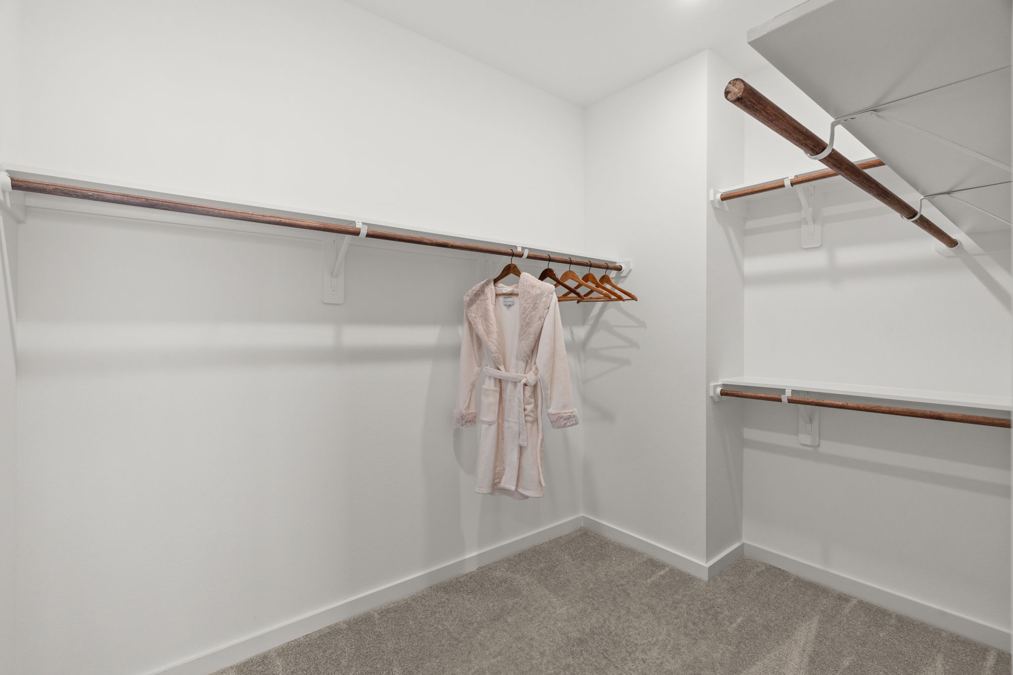 11303 Stonework Grv Lane Houston, TX 77076 - Photo 28 of 39 a view of walk in closet with empty racks