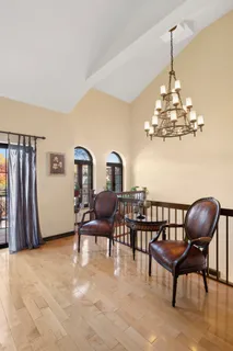 a view of a dining room with furniture wooden floor and chandelier