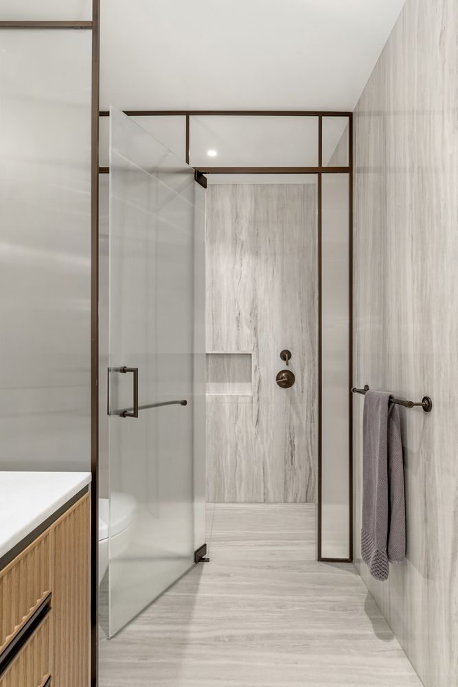 a bathroom with a glass door shower