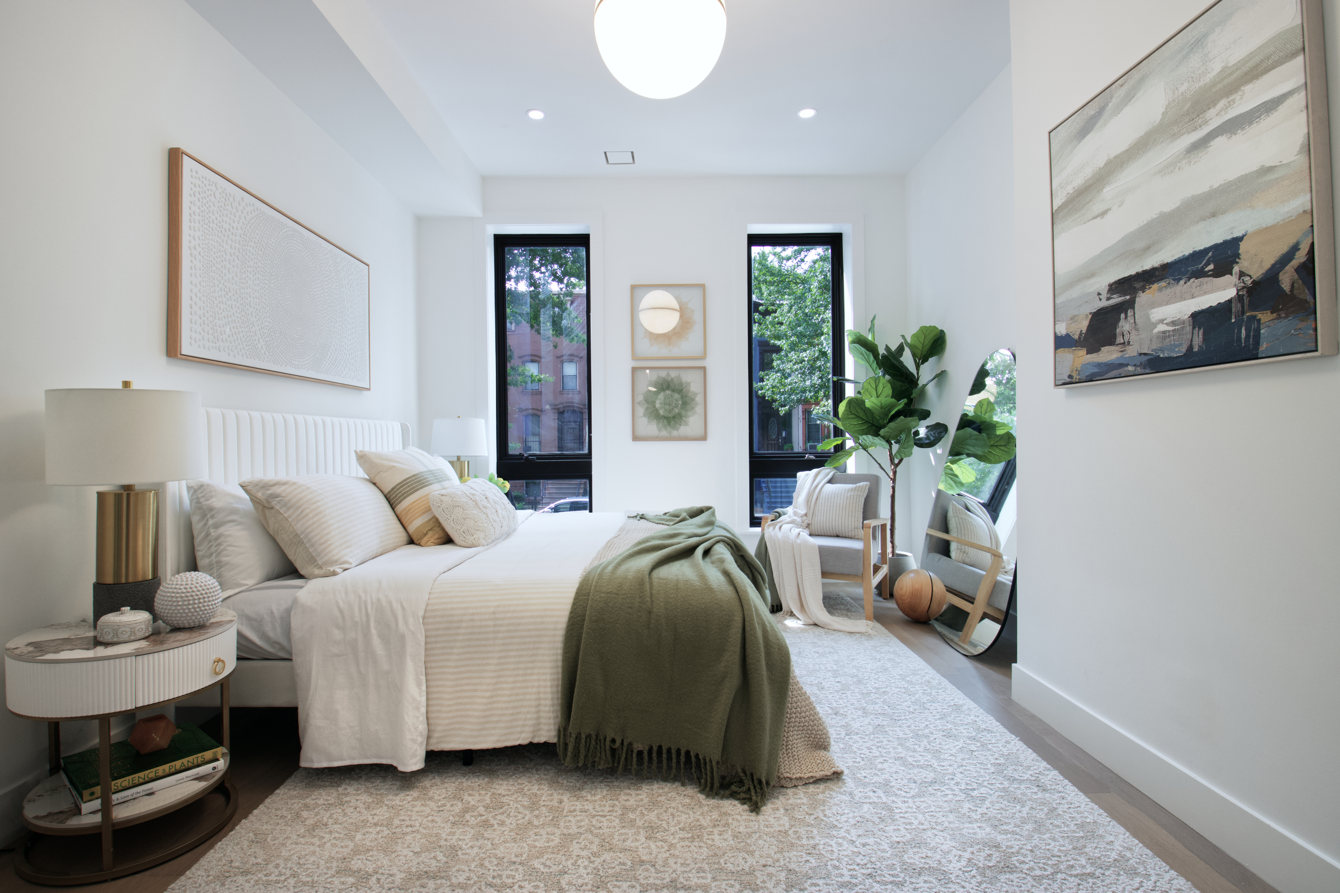 255 Macon Street Brooklyn, NY 11216 - Photo 13 of 36 a spacious bedroom with a bed a couch and potted plant