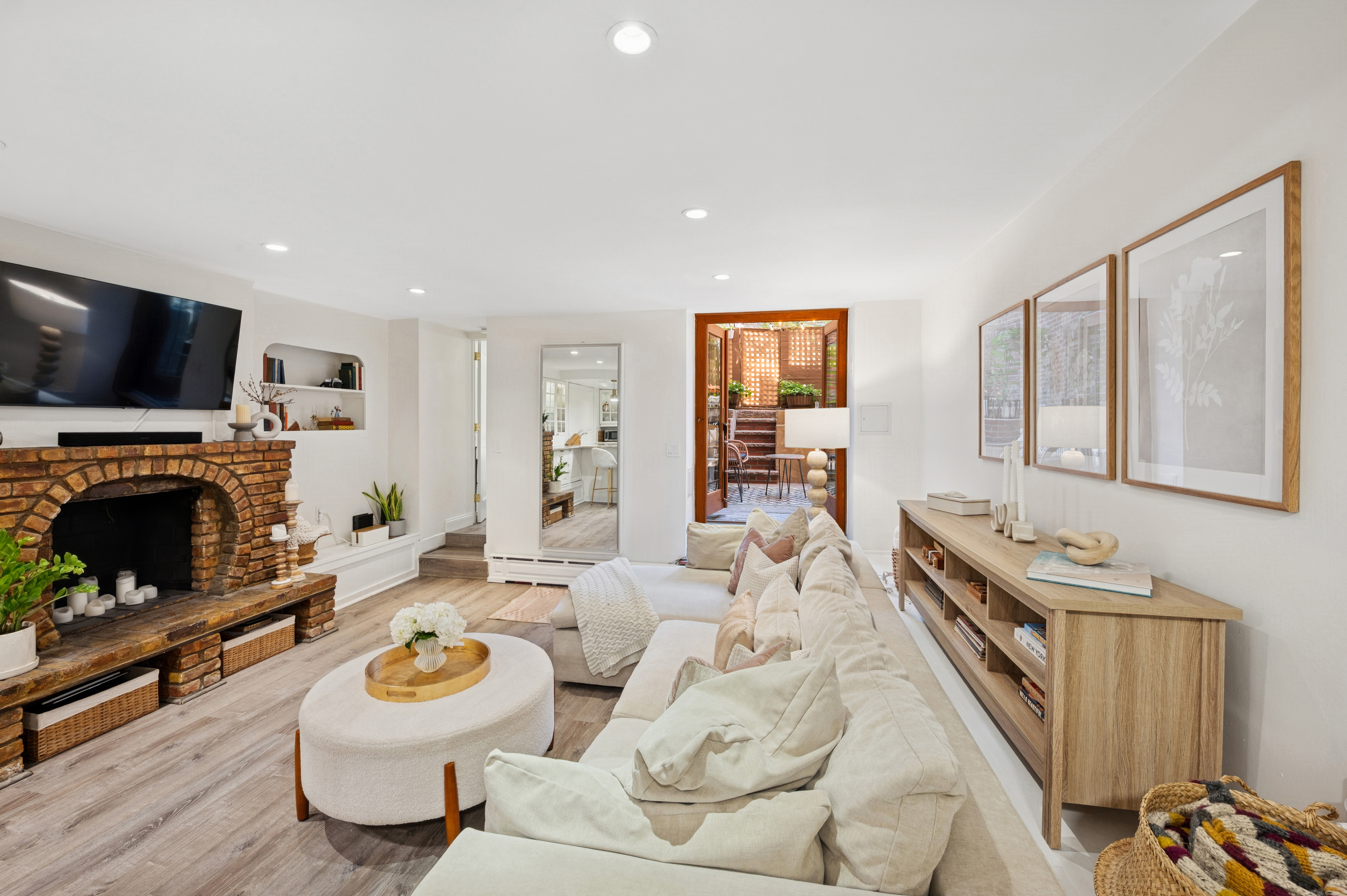 118 West 81st Street, Unit G Manhattan, NY 10024 - Photo 4 of 18 a living room with furniture a flat screen tv and a fireplace