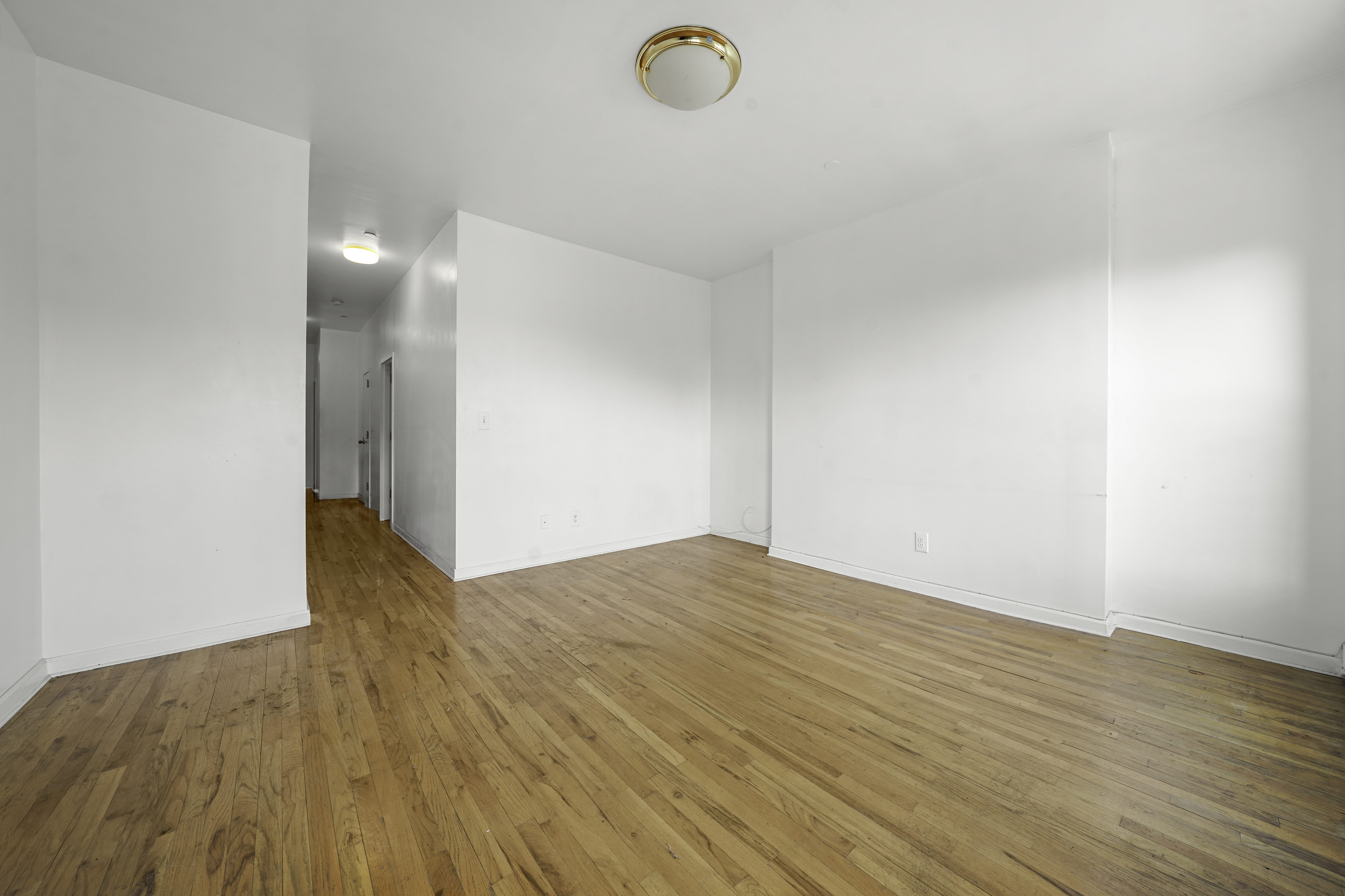 163 Lenox Avenue, Unit 5A Manhattan, NY 10026 - Photo 5 of 16 a view of empty room with wooden floor