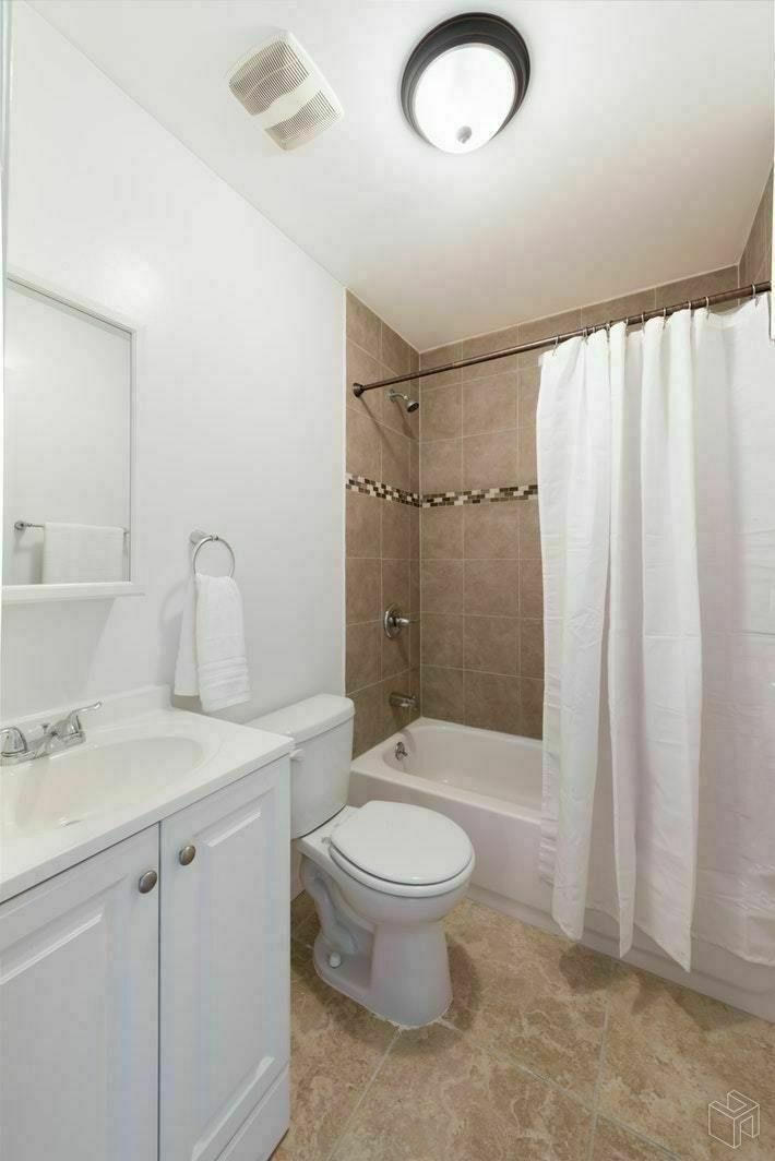 54 Lott Street, Unit 2 Brooklyn, NY 11226 - Photo 6 of 9 a bathroom with a sink a toilet and shower