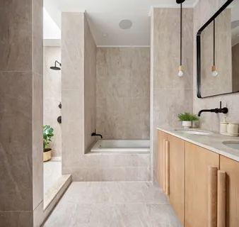 a bathroom with a granite countertop sink a mirror a bathtub and shower